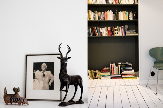 Semi-hidden bookshelf with black wall and shelfs.